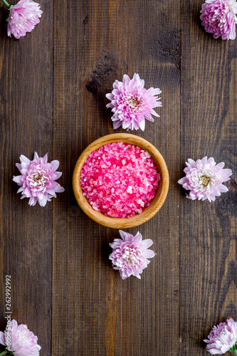 pink spa salt for aroma therapy with flower fragrance on wooden background top view