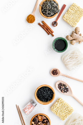 Chinese and Japanese food cooking with ginger, spices and noodles on white background top view mockup