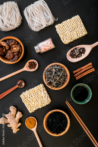 Geometric design with Chinese, Japanese products, noodles, weeds. spices, mushrooms on black background top view pattern photo