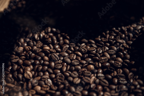 Roasted coffee beans. Dark background with copy space