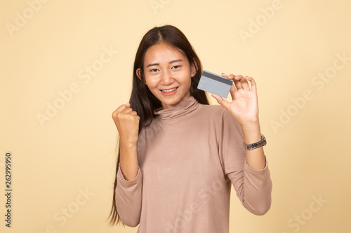 Young Asian woman fist pump with blank card.