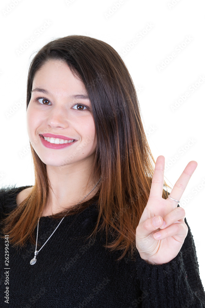 Happy young woman showing peace gesture with finger