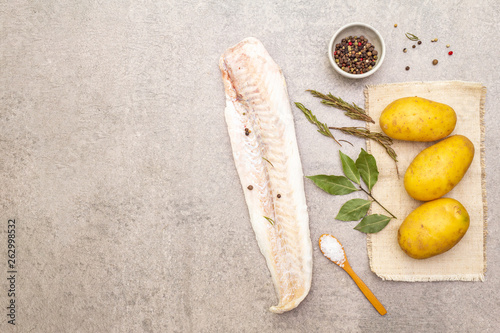 Tableau sur toile Raw young potatoes and frozen hake fillets