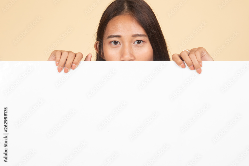Close up of young Asian woman behind a blank sign. Close up of young Asian woman behind a blank sign.