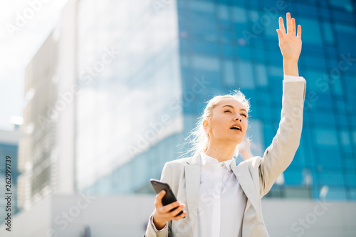 Girl calling a cab. Young businesswoman on the phone, catching a taxi. Free Download Girl calling a cab. Young businesswoman on the phone, catching a taxi. - GFXLoad