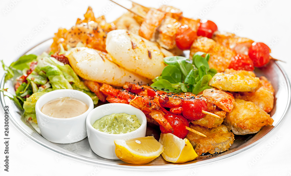A plate with meat dishes, kebabs, bishtex, sauces and various croutons. A plate with meat dishes, kebabs, bishtex, sauces and various croutons.