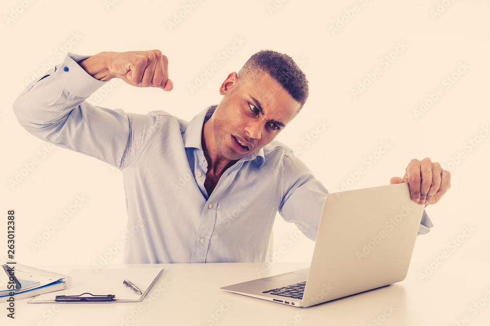 Obraz premium Portrait of angry and frustrated businessman looking at laptop desperate, overworked and stressed