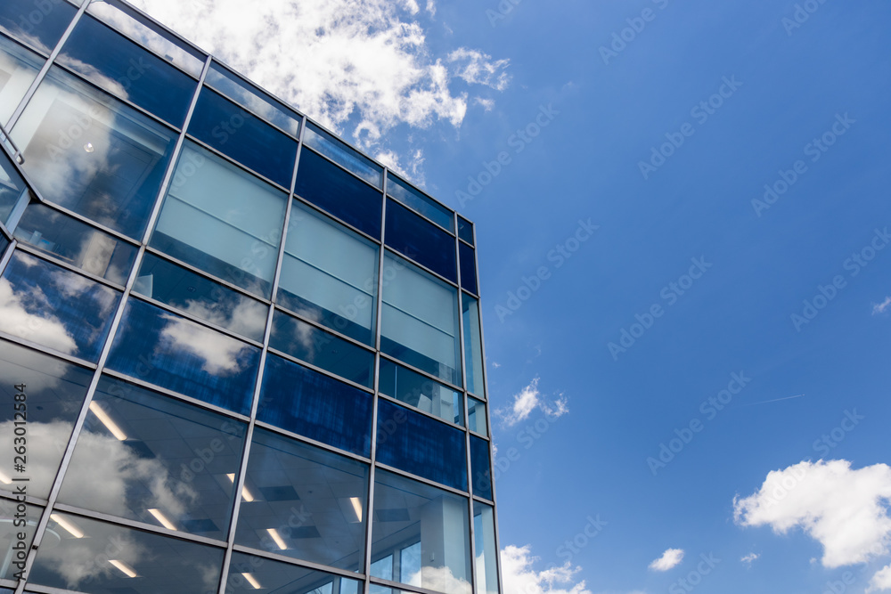 White Clouds and Blue Sky Reflection on Office Building White Clouds and Blue Sky Reflection on Office Building