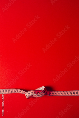 roulette to measure on a red background, diet and waist