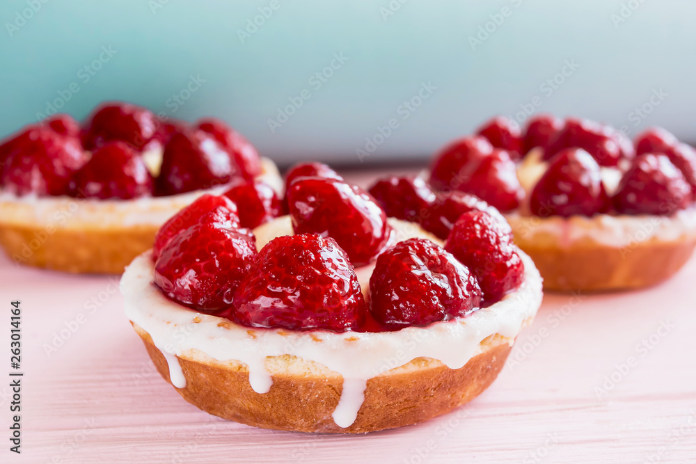 three panna cotta cakes with cream and raspberries close up on a gentle blue sky and pink background three panna cotta cakes with cream and raspberries close up on a gentle blue sky and pink background