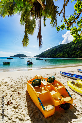 beautiful sunstar, turquoise water and boats at port launey, seychelles