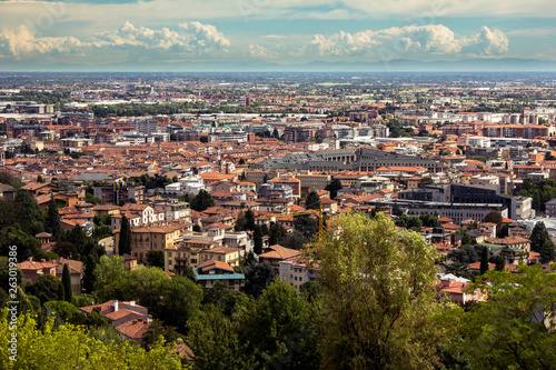 Beautiful plain brown roofs panorama of the Italian Bergamo city. View from the upper side of Bergamo (from old town). Building roofs, cityscape and skyline. © Daniil