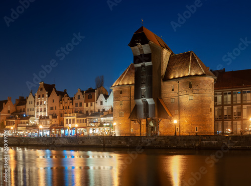 Old town in Gdansk, Poland at night. Riverside with the famous Crane and city reflections in the Motlava river.
