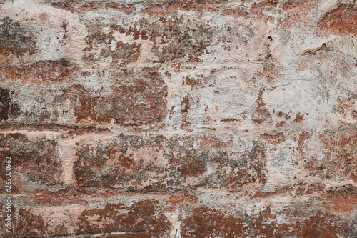 Urban grunge texture background. Abstract pattern on brown stucco backdrop. Cracked red old dilapidated wall, grunge textured. Vintage plaster wall background. 