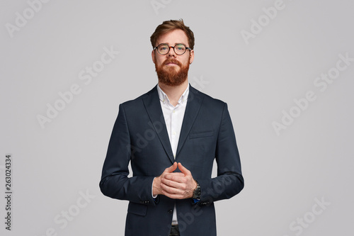 Executive man in trendy suit looking at camera