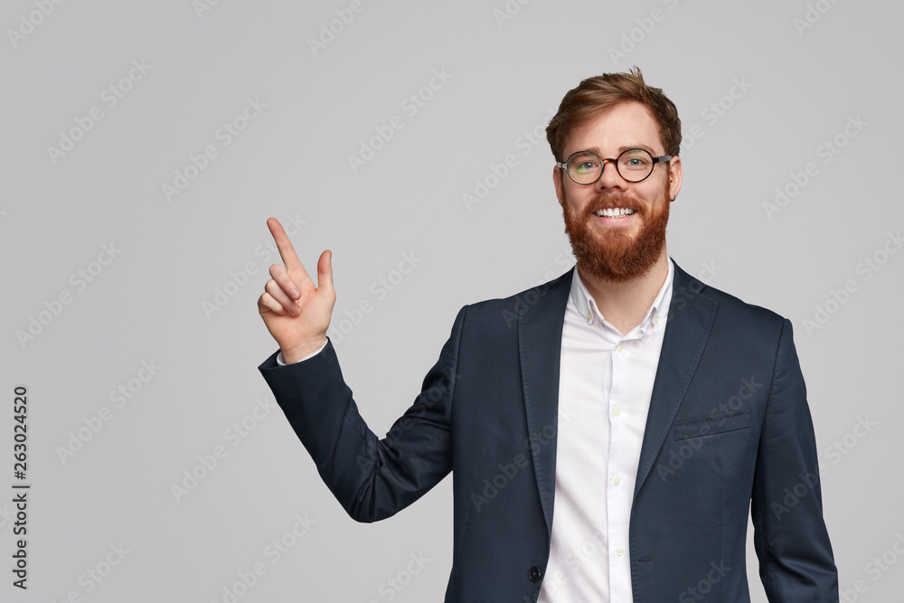 Friendly businessman pointing at empty space Friendly businessman pointing at empty space