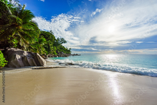 Paradise tropical beach with rocks,palm trees and turquoise water in sunshine, seychelles 1