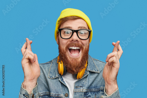 Excited hipster wishing to win lottery photo