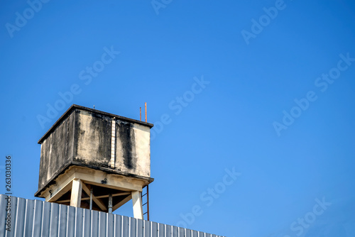 Old water tank with blue sky background
