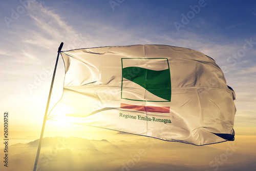 Foto Emilia-Romagna region of Italy flag waving on the top sunrise mist fog