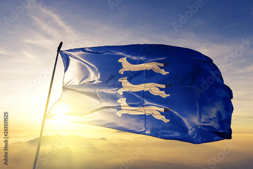 Southern Ostrobothnia region of Finland flag waving on the top sunrise mist fog photo