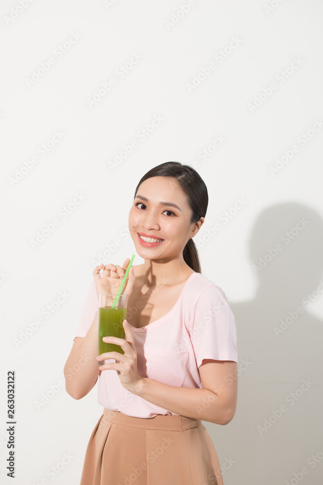Go green. Young beautiful woman enjoying a healthy raw fruit vegetable juice. Studio shot. Go green. Young beautiful woman enjoying a healthy raw fruit vegetable juice. Studio shot.