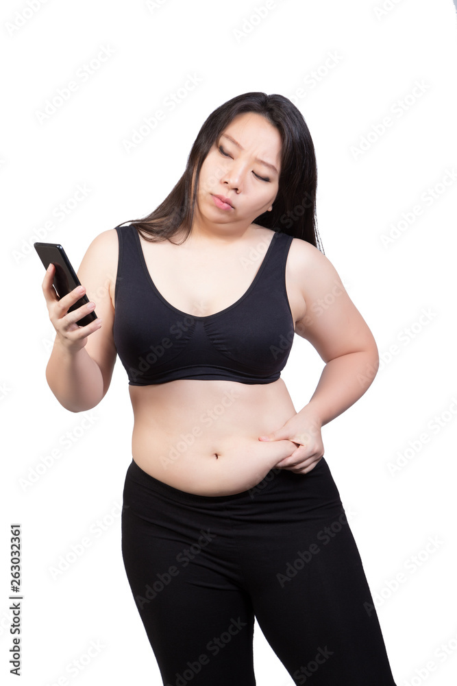 Fat woman squeeze belly fat looking at mobile phone face worry doubt about  weight loss concept isolated on white background Stock Photo