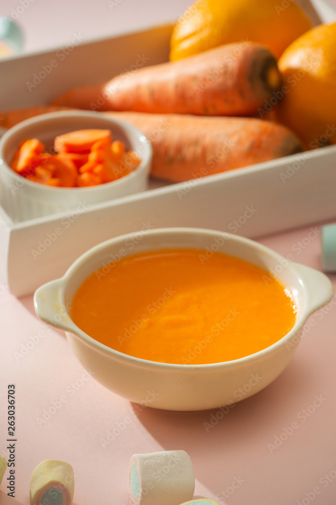 Carrot baby puree in bowl isolated on light background Carrot baby puree in bowl isolated on light background