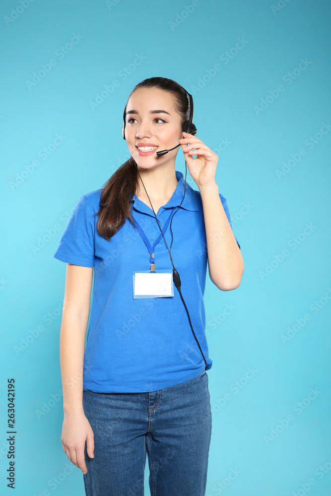 Portrait of technical support operator with headset on color background