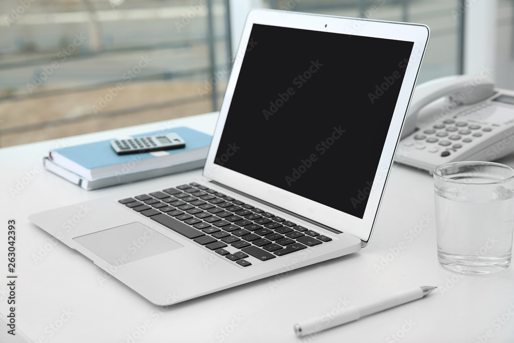 Stylish workplace with modern laptop on desk Stylish workplace with modern laptop on desk