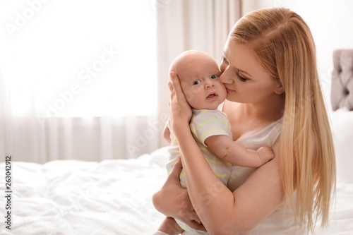 Mother with her little baby in bedroom