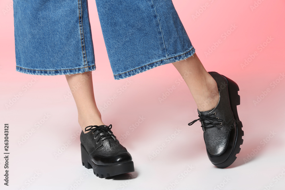 Woman in stylish shoes on color background, closeup Woman in stylish shoes on color background, closeup