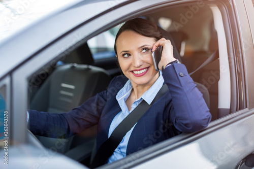 Woman using smartphone while driving a car