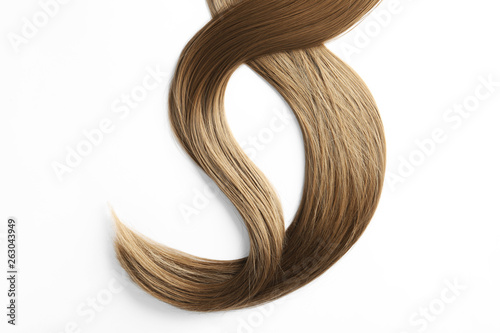Beautiful strands of brown hair on white background, top view. Hairdresser service