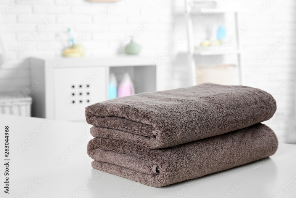 Stack of fresh towels on table in bathroom. Space for text Stack of fresh towels on table in bathroom. Space for text