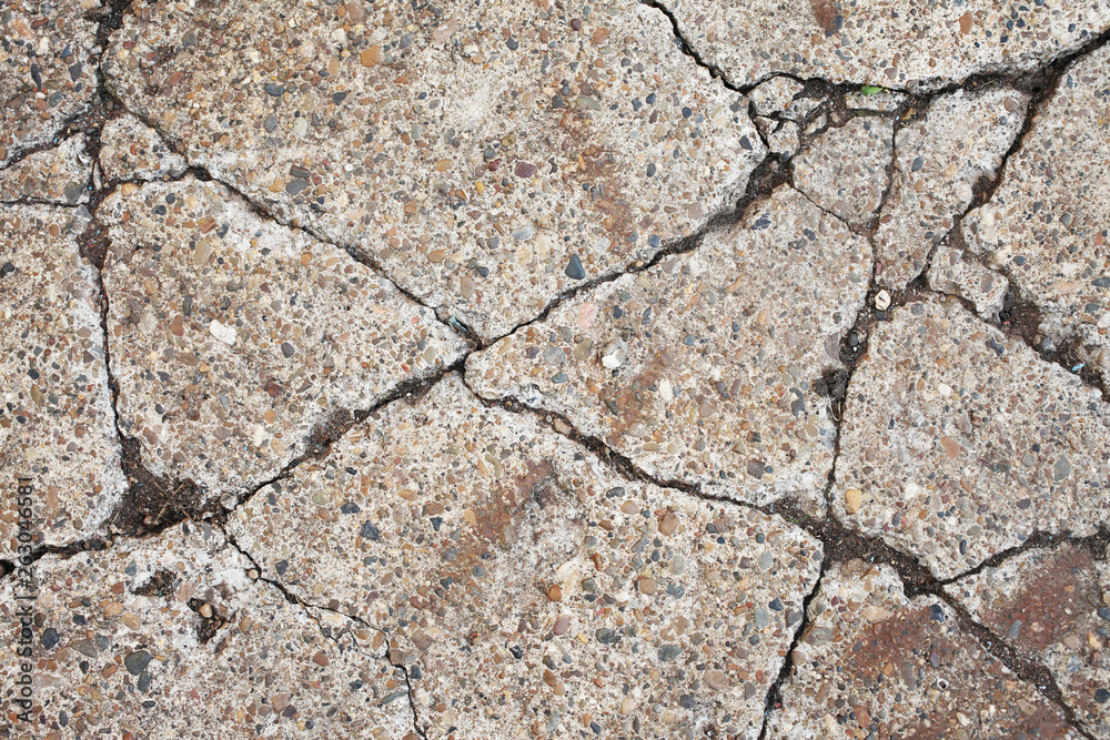 Fototapeta premium Old worn and cracked asphalt with cracks.