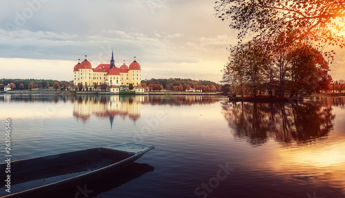 Wonderful Autumn Landscape. Famouse Moritzburg Castle near Dresden under sunlit. with colorful sky over the Lake, Awesome artistic Picture. Amazing Picturesque Scene. Creative image. Postcard