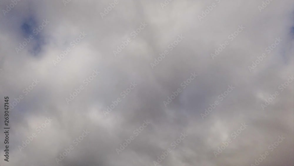 Timelapse sky with amorphous gray nimbostratus clouds blow from left to right