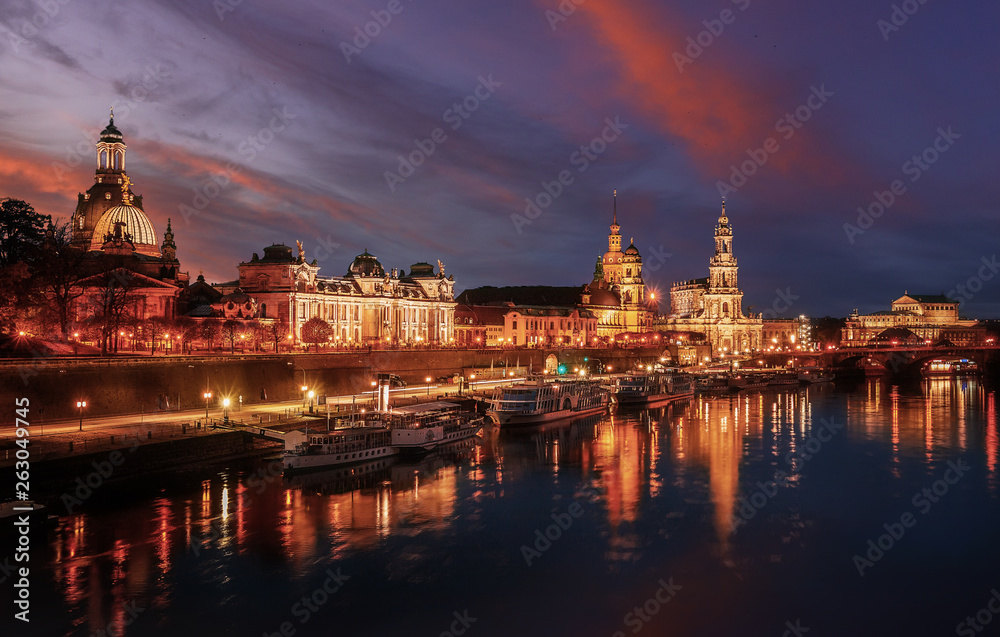 Awesome colorful scene during sunset at the Old Town in Dresden, Saxony, Germany. Famouse Sights: Frauenkirche, Hofkirche, Semperoper with reflected in calm water Elbe river. picturesque scenery. Awesome colorful scene during sunset at the Old Town in Dresden, Saxony, Germany. Famouse Sights: Frauenkirche, Hofkirche, Semperoper with reflected in calm water Elbe river. picturesque scenery.