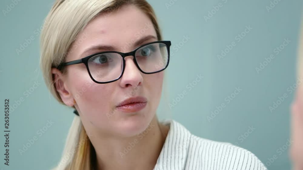 Young woman psychologist in glasses is emotionally talking with her client. Young woman psychologist in glasses is emotionally talking with her client.
