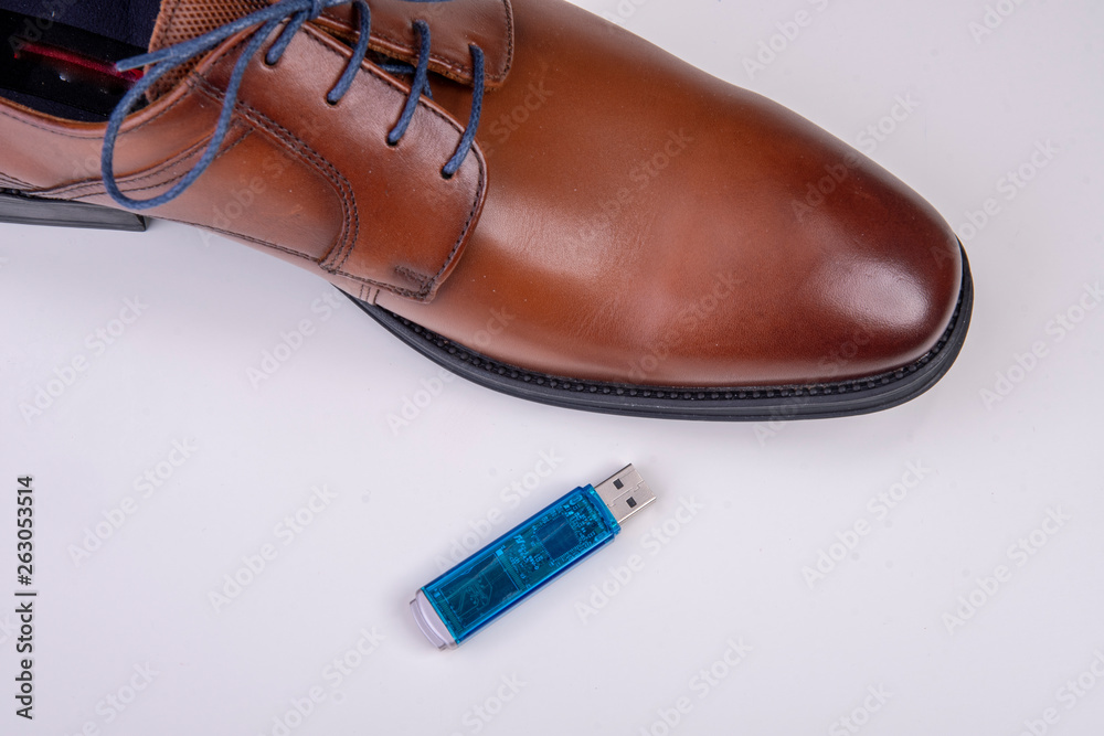 data stick with business shoe against white background