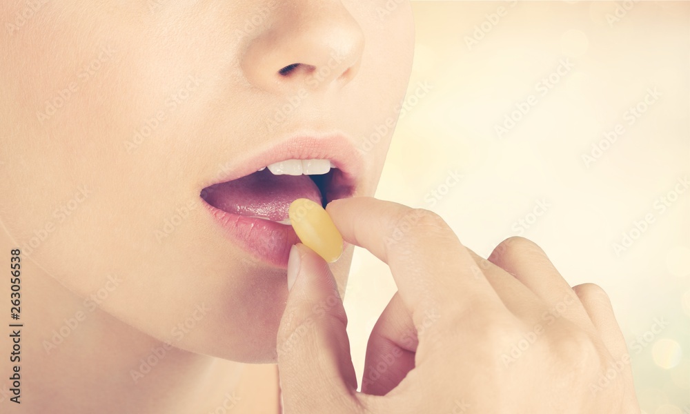 Woman taking pill, close up, healthcare concept Woman taking pill, close up, healthcare concept