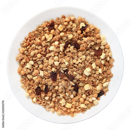 Muesli with raisins on a plate top view isolated on white background with clipping path.