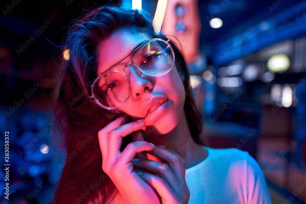 portrait of a beautiful young woman with glasses in futuristic neon light portrait of a beautiful young woman with glasses in futuristic neon light