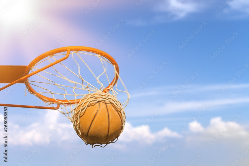 Basketball ball hitting basket on white background