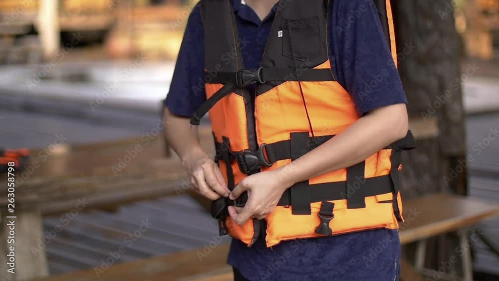 asian guy wearing life vest before rafting asian guy wearing life vest before rafting