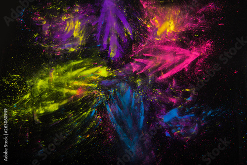Colorful powder on black background. Abstract print. Holi paint photo