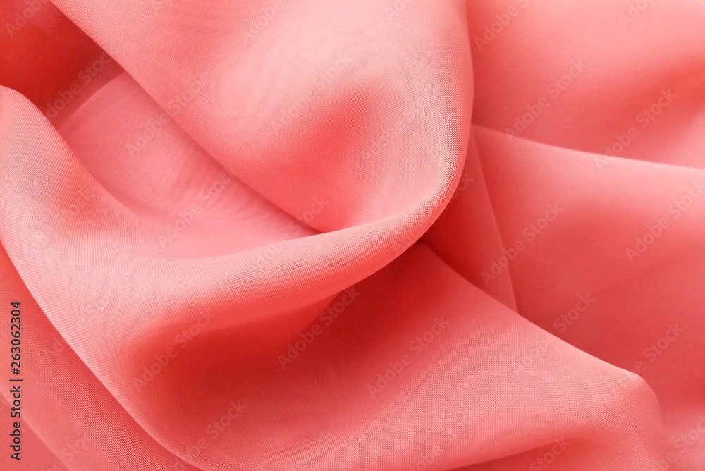 Beautiful abstract background (texture) of a thin delicate transparent veil (chiffon, tulle) color of year 2019 Living Coral. Polyester syntetic or natural. Comfortable home textile. Beautiful abstract background (texture) of a thin delicate transparent veil (chiffon, tulle) color of year 2019 Living Coral. Polyester syntetic or natural. Comfortable home textile.