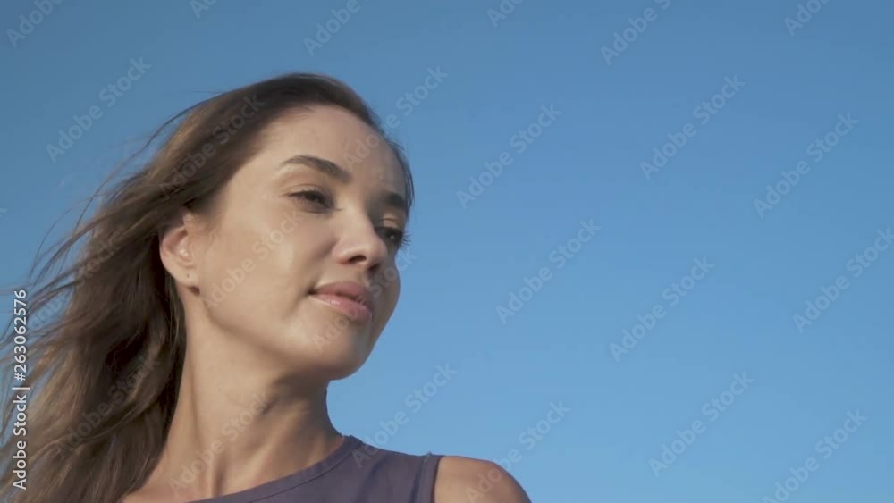 A woman looking to the blue sky with hope Stress free concept A woman looking to the blue sky with hope Stress free concept