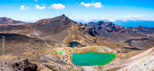 Panorama Landscape view of a beautiful of Tongariro Crossing track on a beautiful day with blue sky, North Island, New Zealand. © Klanarong Chitmung